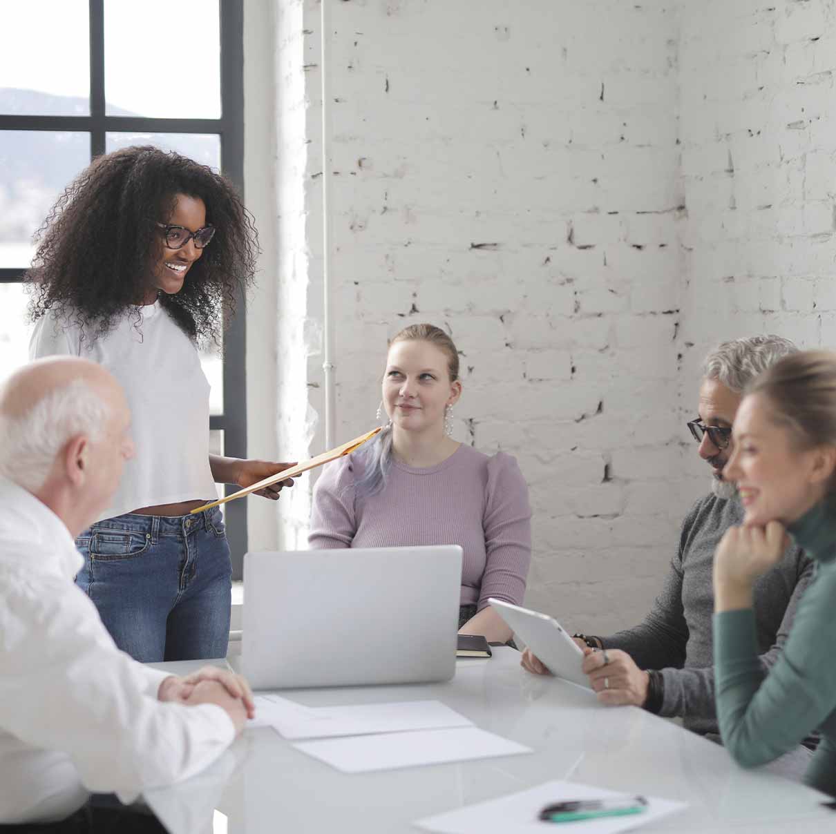 Delivering Expertise Diverse group of people in conference room